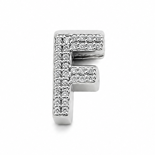 Sterling silver letter F initial charm with sparkling stones on the front. On a white background.