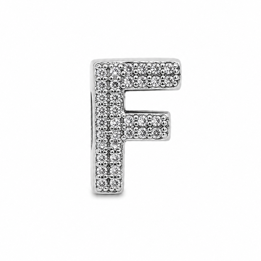 A sterling silver letter 'F' initial charm, paved with small clear cubic zirconia stones, shown on a plain white background.