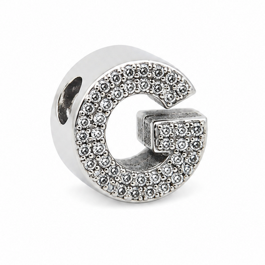 Sterling silver letter 'G' initial charm with cubic zirconia stones covering the front of the letter. On a white background.
