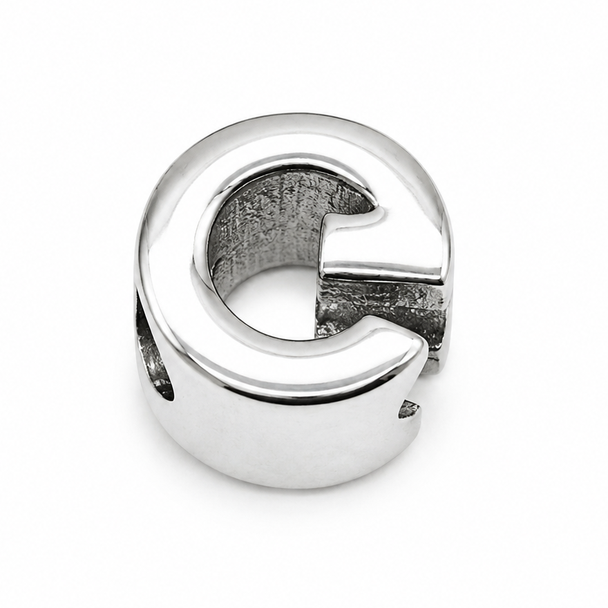 Sterling silver letter 'G' initial charm shown from the back which is polished silver. On a white background.