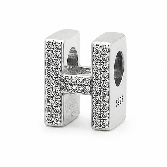 A sterling silver letter 'H' charm embellished with pavé-set clear crystals, shown on a plain white background.