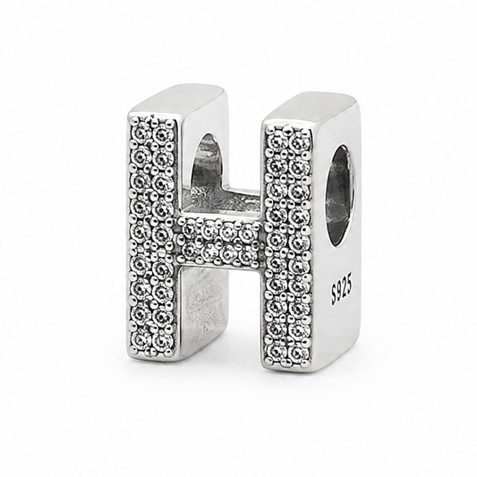 A sterling silver letter 'H' charm embellished with pavé-set clear crystals, shown on a plain white background.