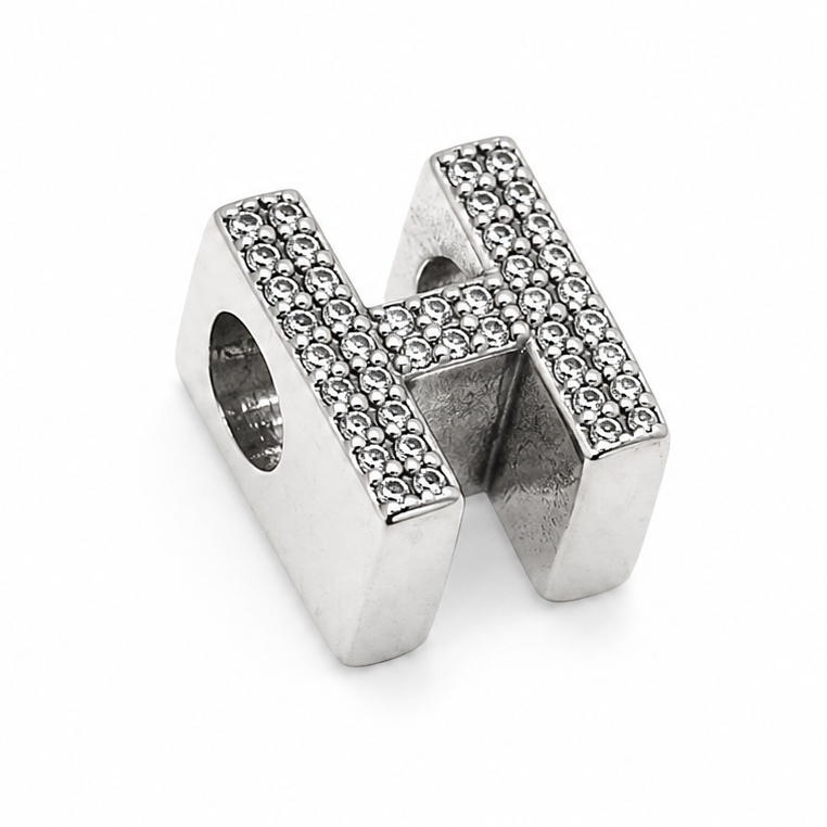 A sterling silver letter 'H' charm embellished with small clear pavé stones, shown on a clean white background.