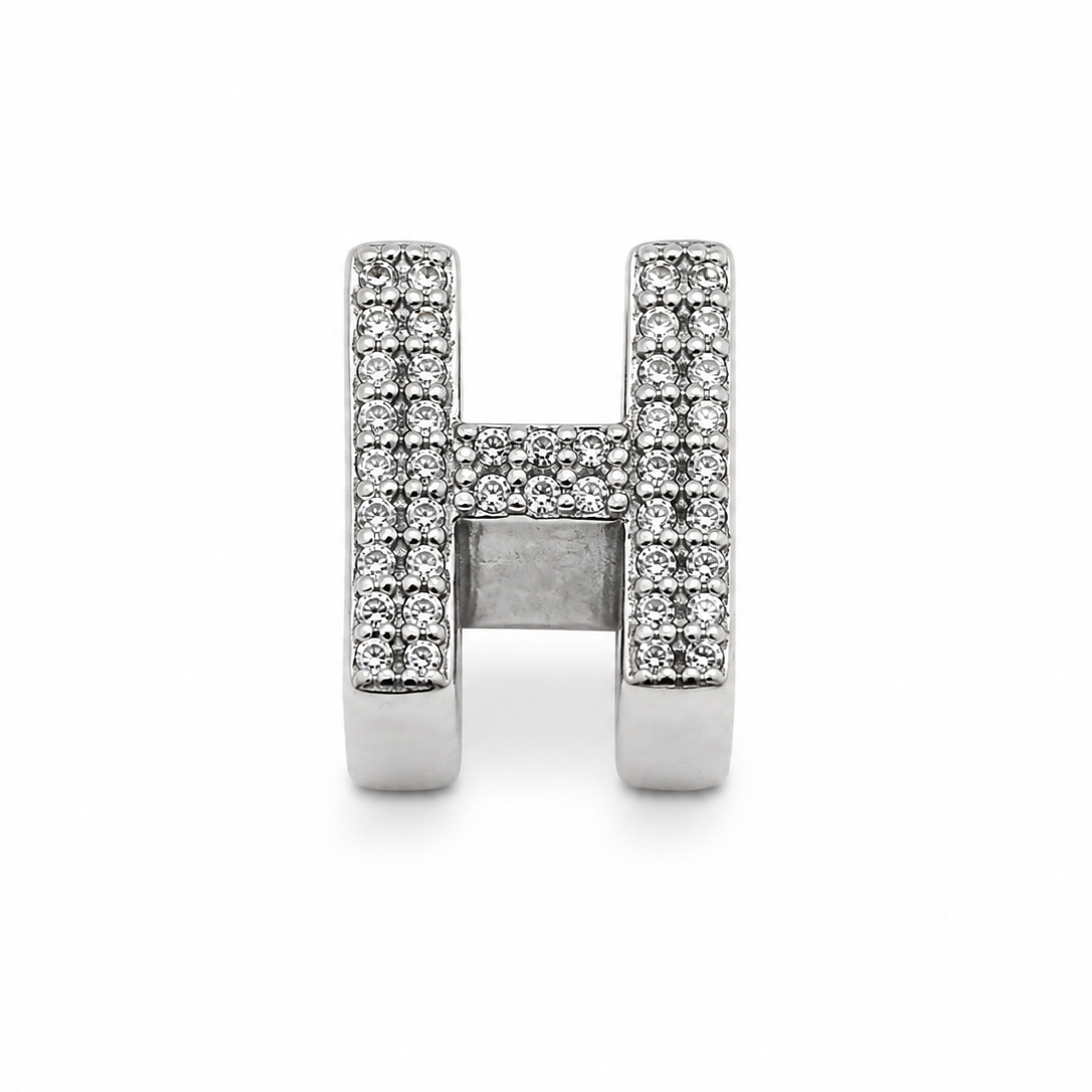 A sterling silver letter 'H' charm embellished with pavé-set clear crystals, shown on a plain white background.