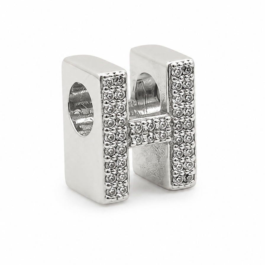 A sterling silver letter 'H' charm embellished with pavé-set clear crystals, shown on a plain white background.