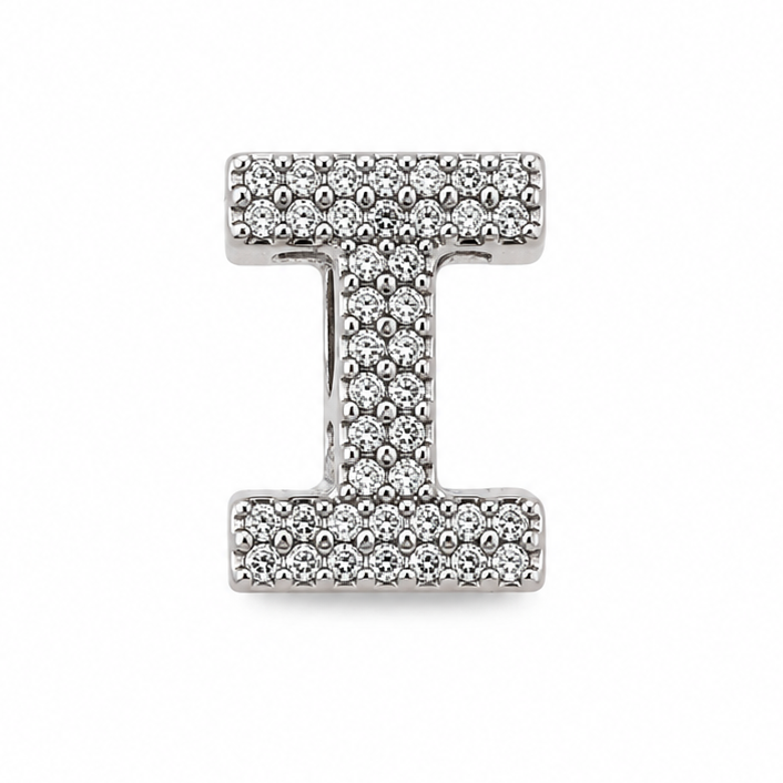 A sterling silver letter 'I' initial charm, paved with small clear stones, centered on a plain white background.