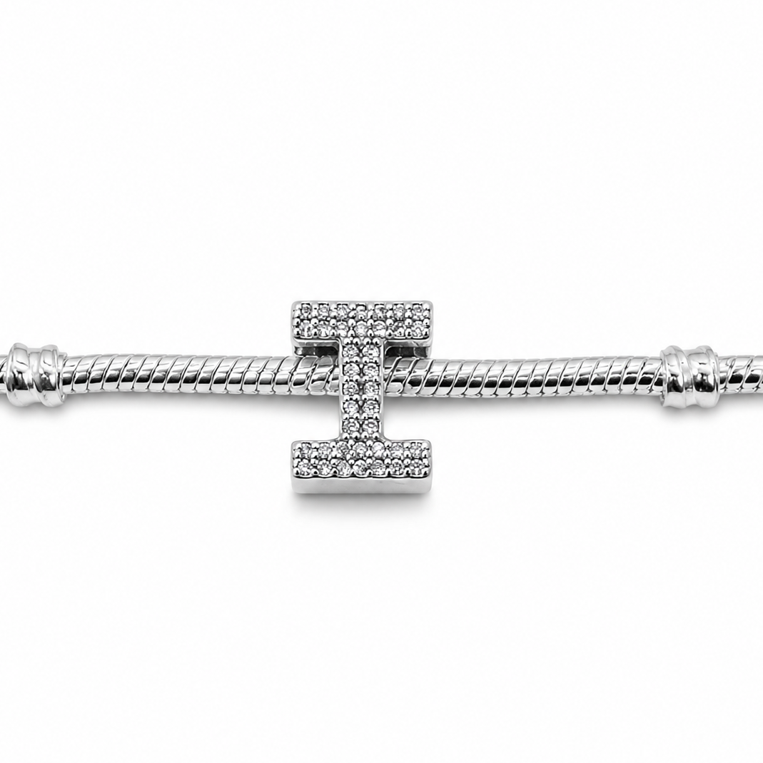 A sterling silver I-shaped charm with pavé-set clear crystals, shown on a silver snake chain against a plain white background.