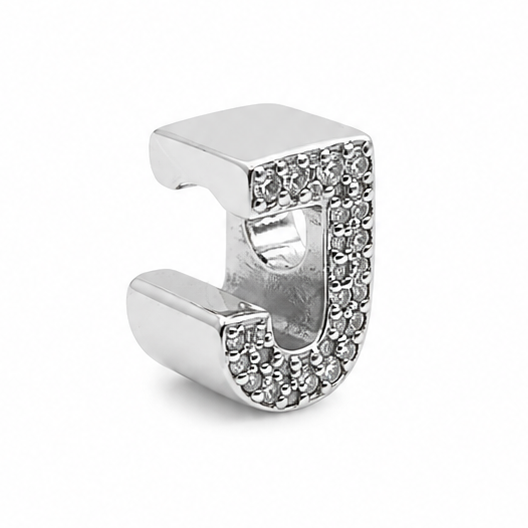 A sterling silver letter 'J' initial charm charm, paved with small clear rhinestones on the front face, shown on a plain white background.