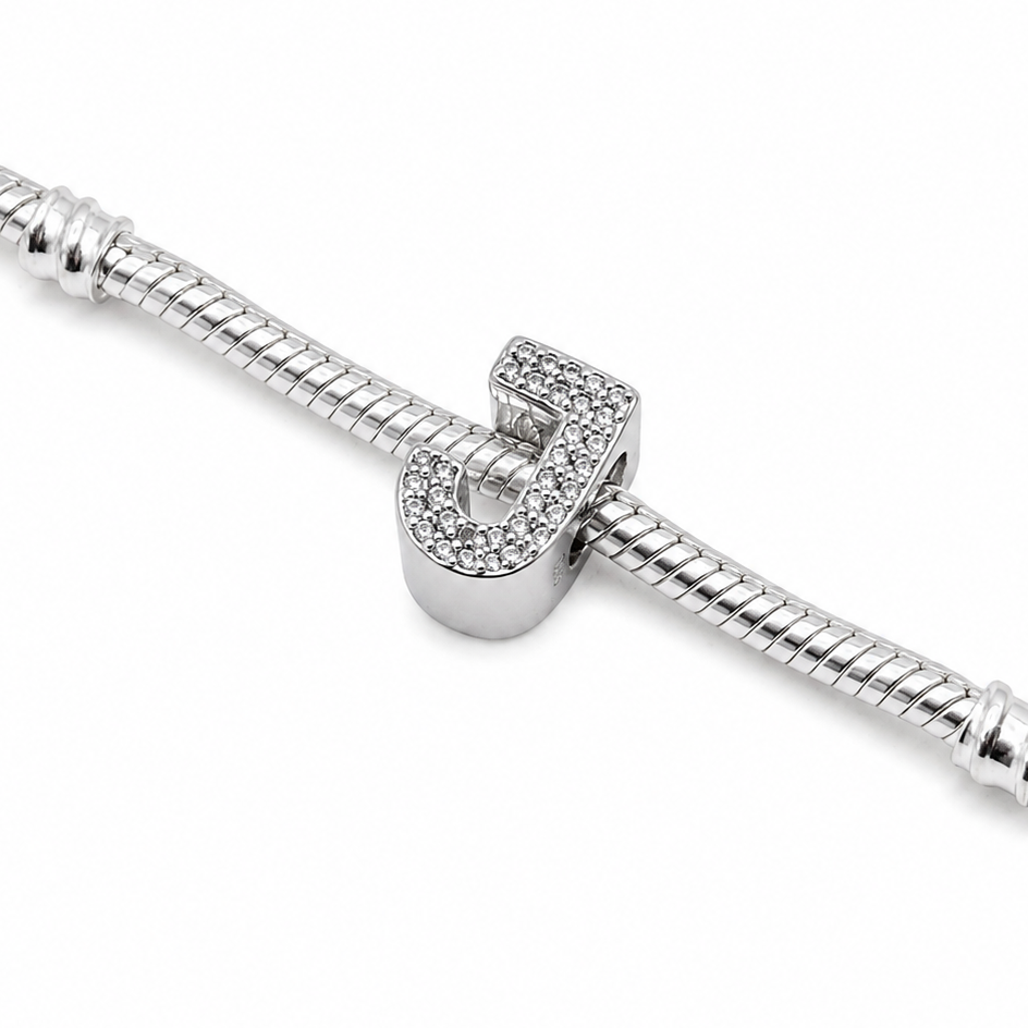 A silver snake chain bracelet featuring a central sterling silver letter 'J' charm encrusted with small clear stones, shown on a plain white background.