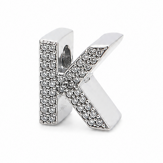 A sterling silver letter 'K' initial charm embellished with small clear pavé stones, shown on a plain white background.