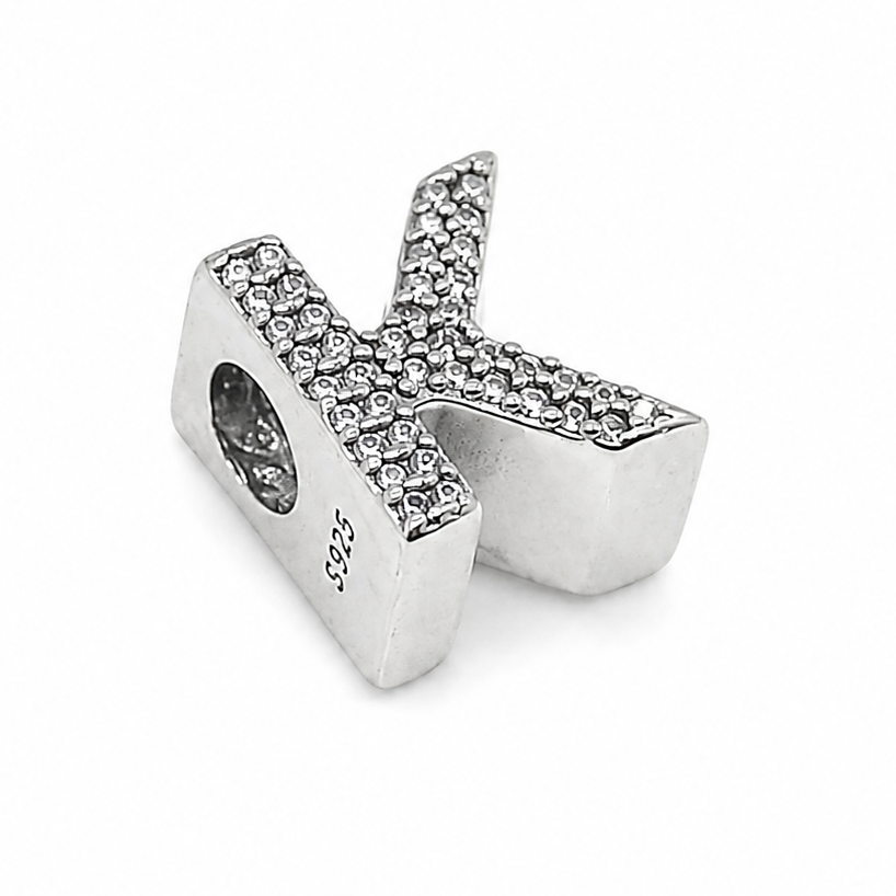 A sterling silver letter 'K' initial charm embellished with small clear pavé stones, shown on a plain white background.