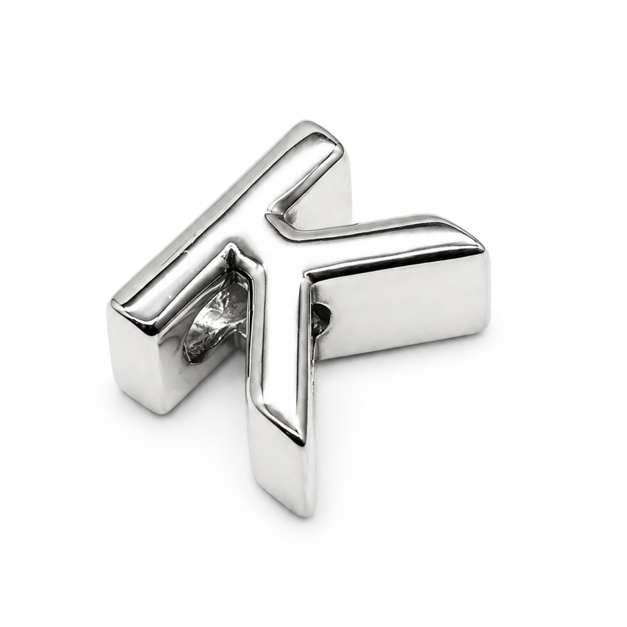 A sterling silver letter 'K' initial charm photographed from the back to show the polished silver, shown on a plain white background.