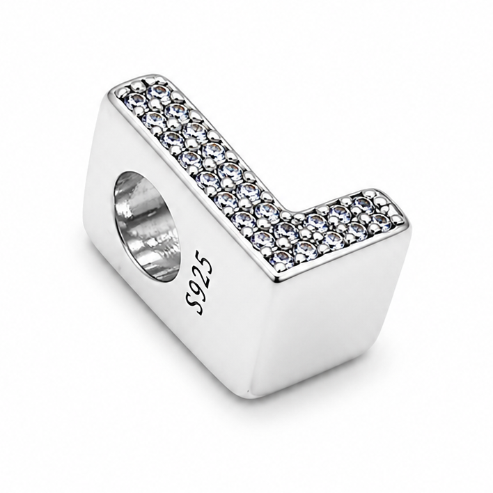 A sterling silver letter 'L' initial charm bead decorated with pavé clear crystals on the top, featuring a .925 sterling silver hallmark on the side, set against a plain white background.