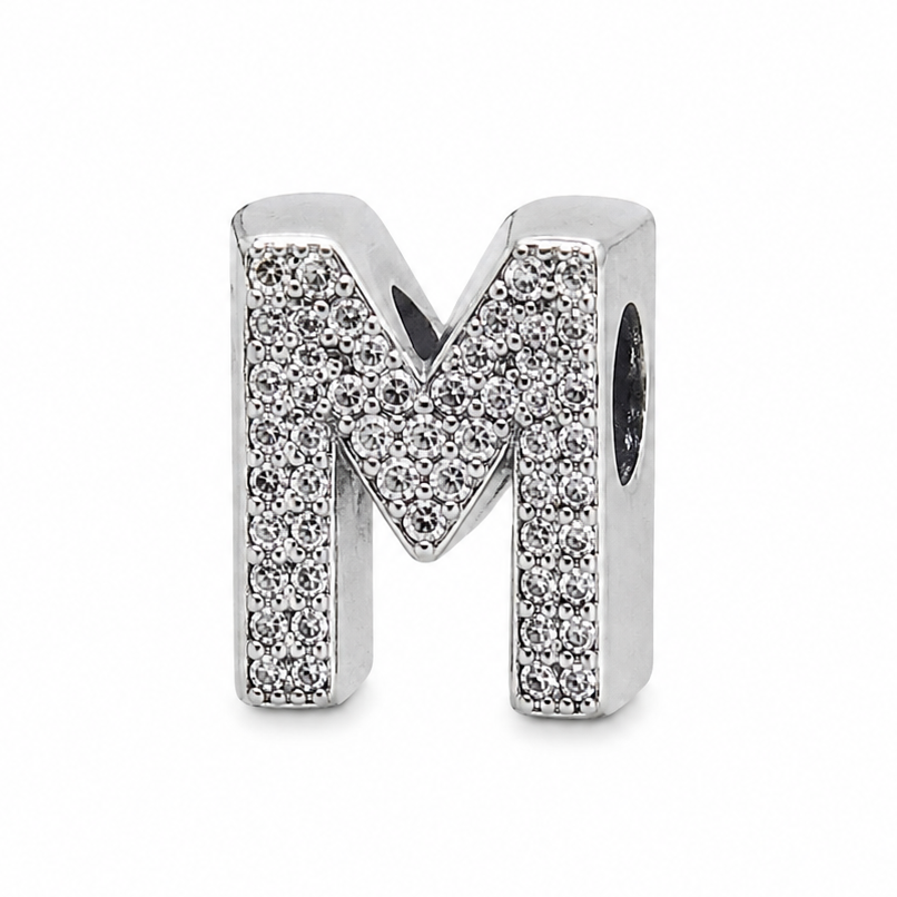 A sterling silver letter 'M' initial charm embellished with pavé-set clear stones, shown on a clean white background.