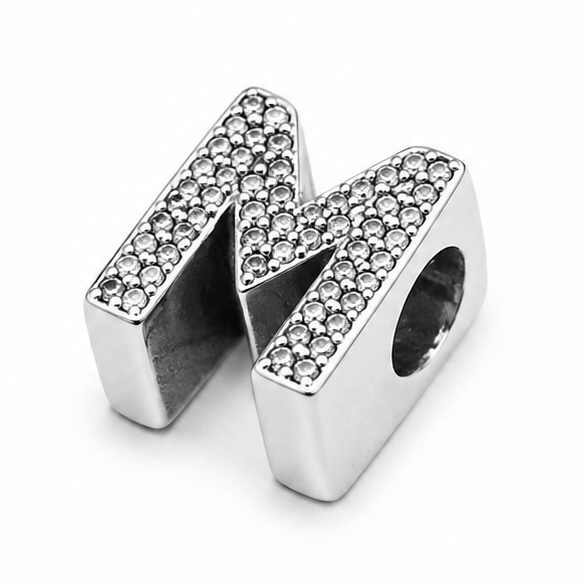 A sterling silver letter 'M' initial charm embellished with pavé-set clear stones, shown on a clean white background.