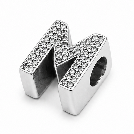 A sterling silver letter 'M' initial charm embellished with pavé-set clear stones, shown on a clean white background.