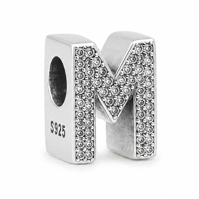 A sterling silver letter 'M' initial charm embellished with pavé-set clear stones, shown on a clean white background.