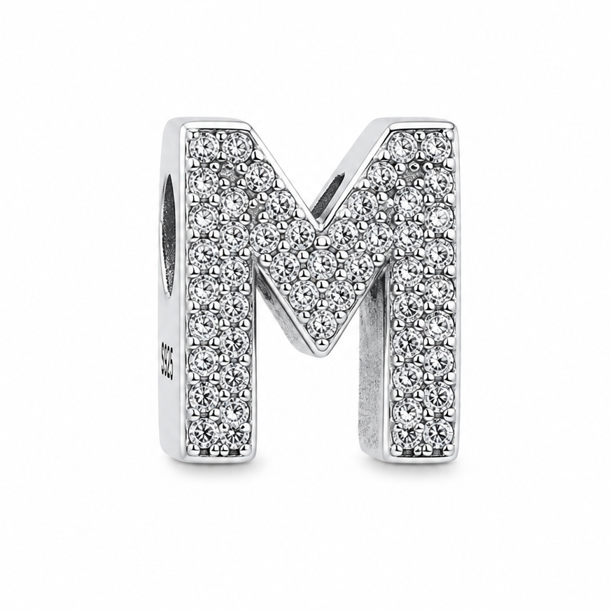 A sterling silver letter 'M' charm embellished with pavé-set clear stones, shown on a plain white background.